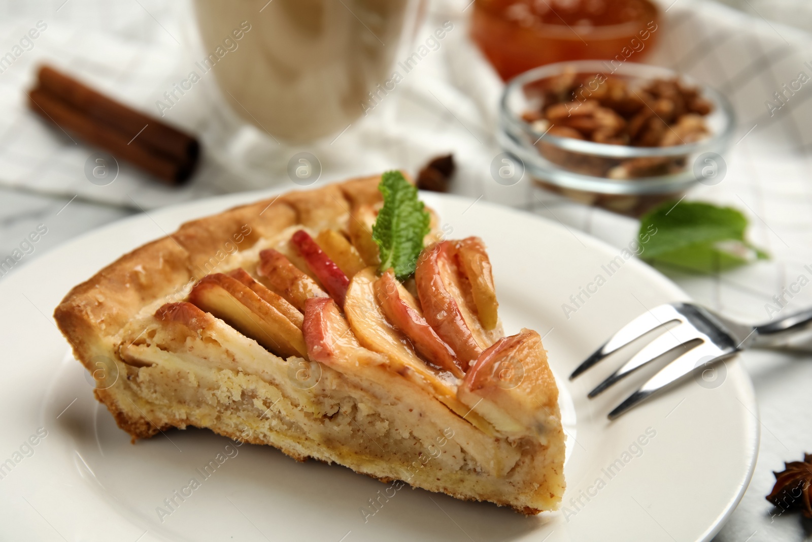 Photo of Slice of delicious apple pie on table, closeup