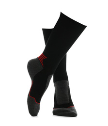 Photo of Woman wearing thermal socks on white background, closeup of legs. Winter sport clothes