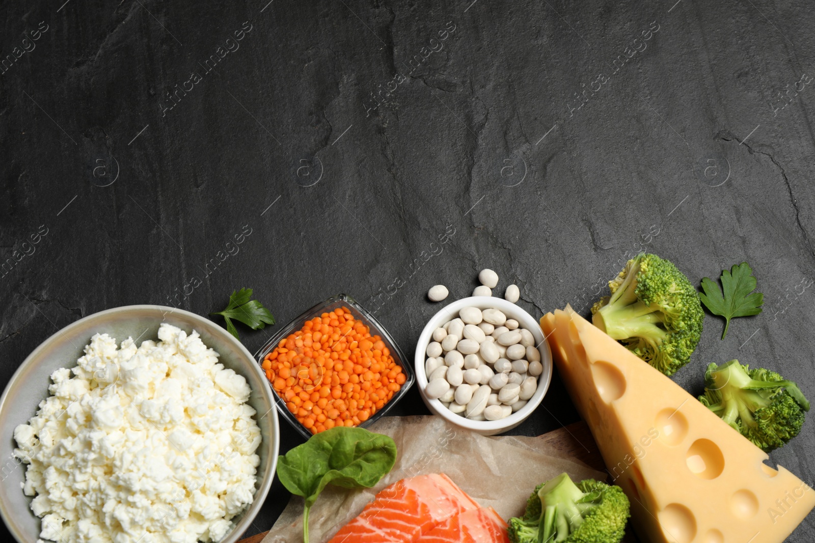 Photo of Products rich in protein on black table, flat lay. Space for text