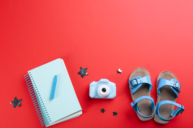 Flat lay composition with little photographer's toy camera on red background. Space for text