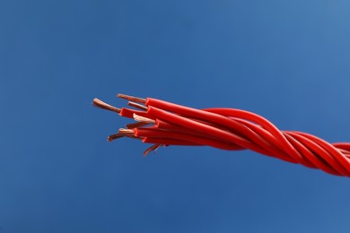 Photo of Closeup view of electrical power cables on blue background