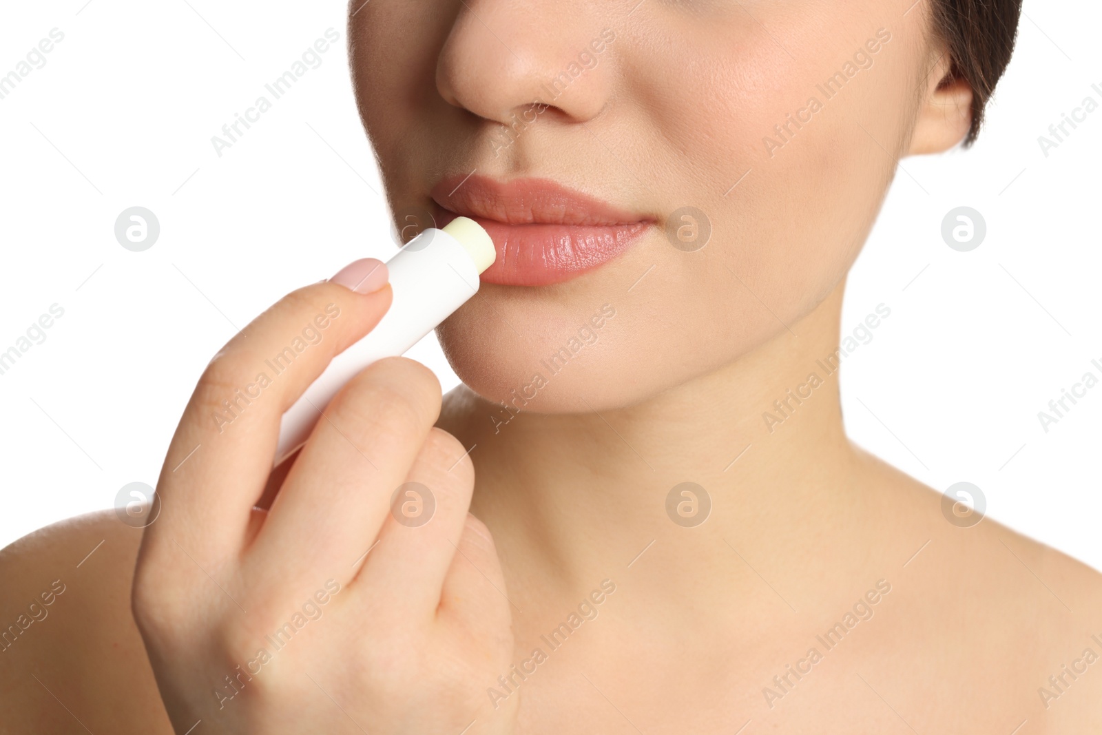 Photo of Young woman applying lip balm on white background, closeup