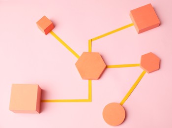 Photo of Business process organization and optimization. Scheme with geometric figures on pink background