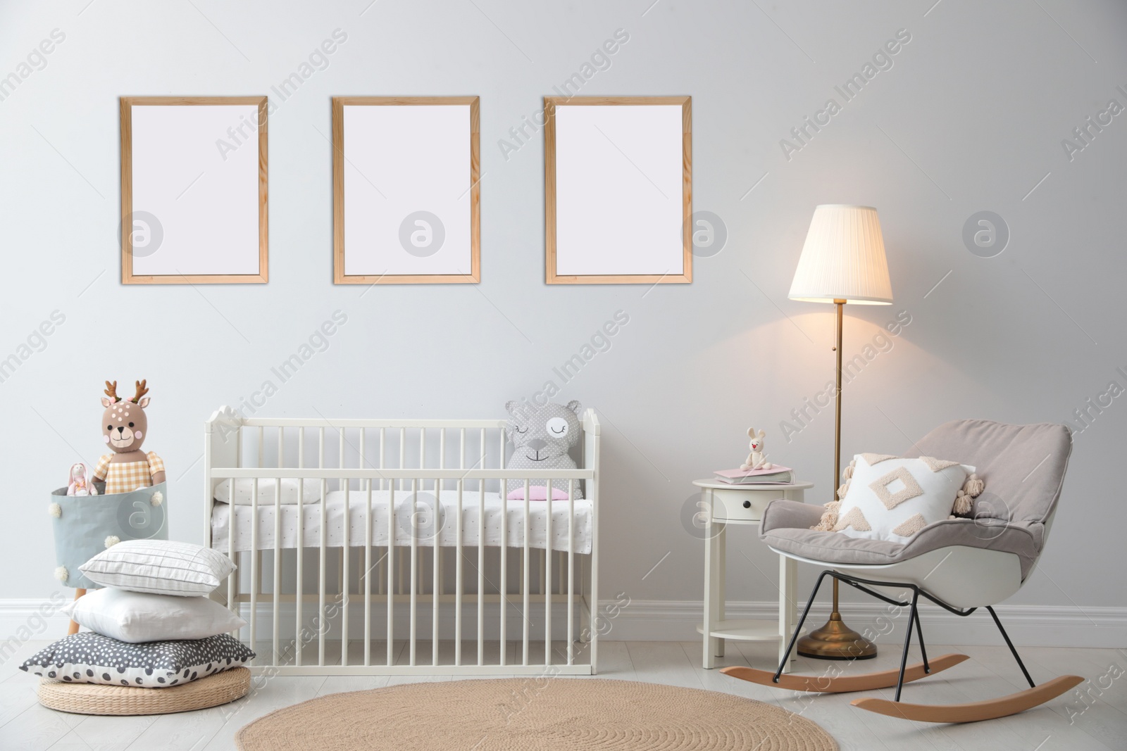 Image of Stylish nursery interior with empty posters on wall. Mockup for design