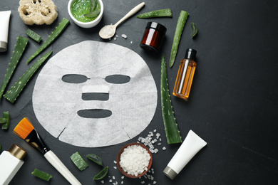 Photo of Flat lay composition with different cosmetic products and aloe on black table