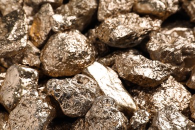 Photo of Pile of gold nuggets as background, closeup