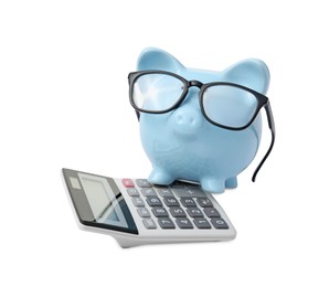 Photo of Calculator and piggy bank with glasses isolated on white