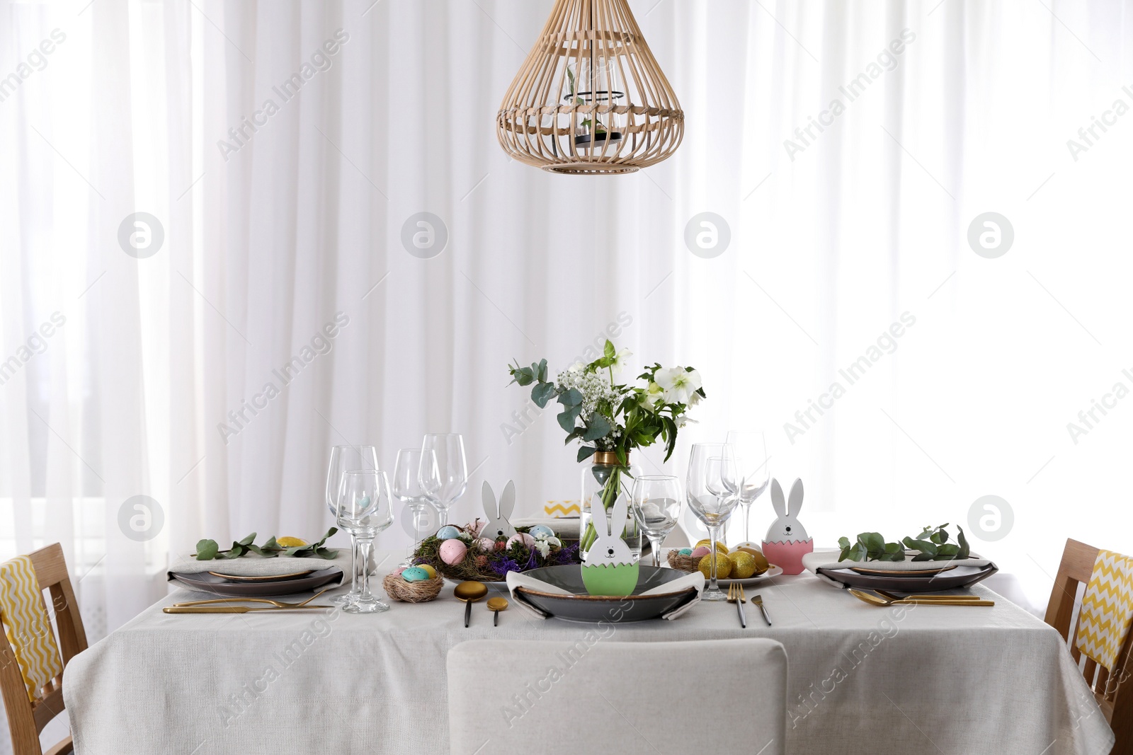 Photo of Beautiful Easter table setting with festive decor indoors