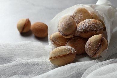 Photo of Delicious walnut shaped cookies with condensed milk on table, closeup