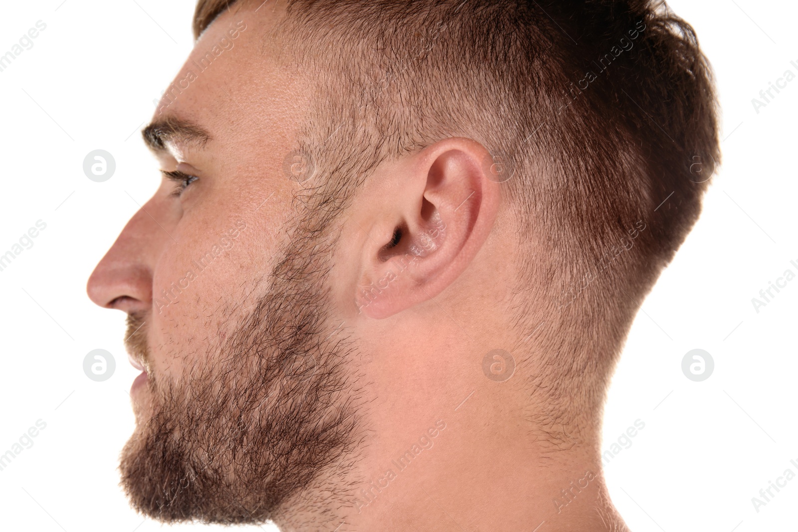 Photo of Young man on white background, closeup. Hearing problem