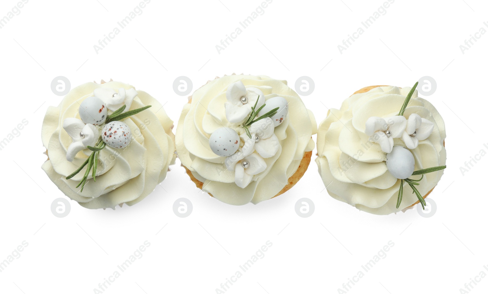 Photo of Tasty Easter cupcakes with vanilla cream isolated on white, top view