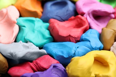 Photo of Pile of colorful plasticine as background, closeup