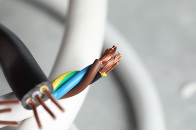 Colorful electrical wires on blurred background, closeup. Space for text