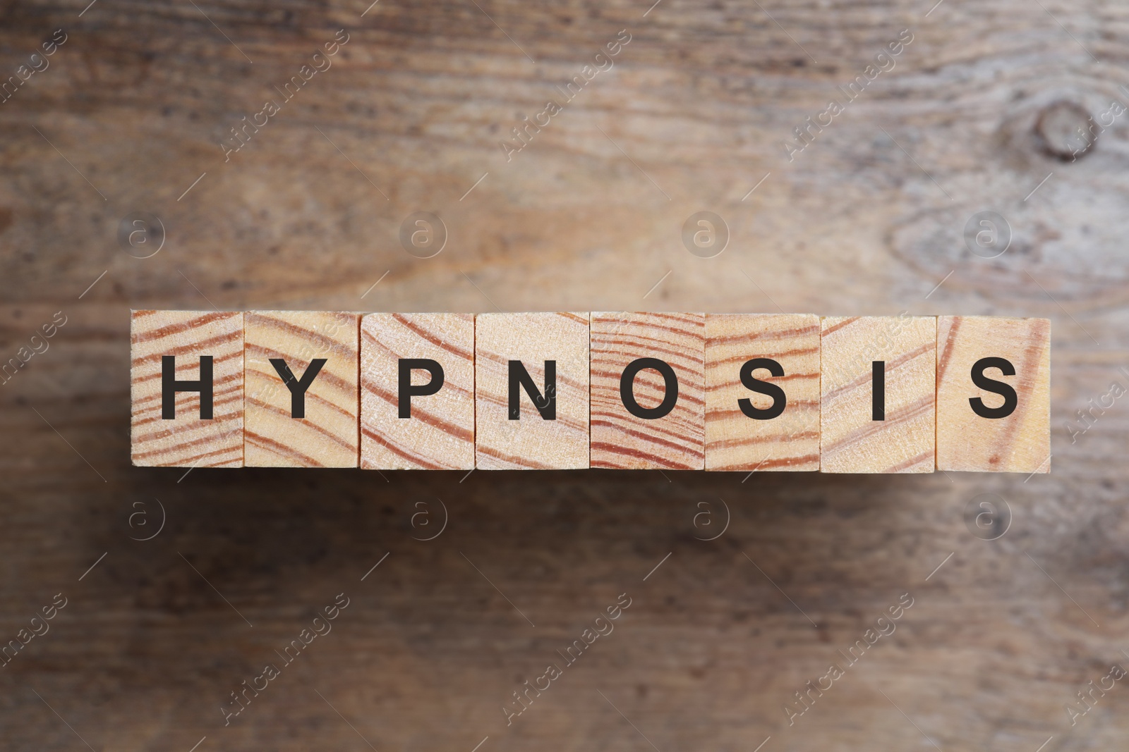 Photo of Blocks with word HYPNOSIS on wooden background, flat lay