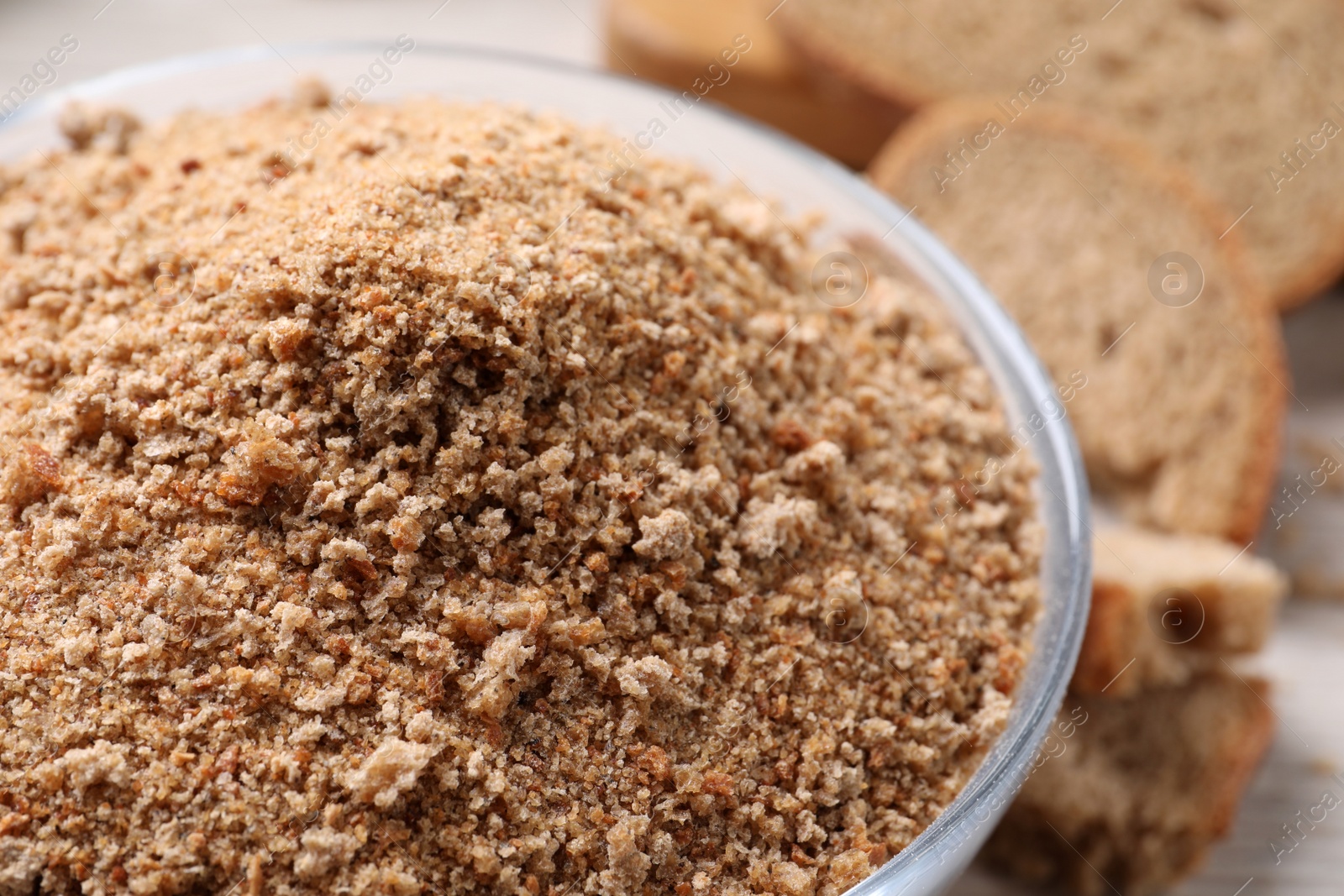 Photo of Fresh breadcrumbs in bowl on table, closeup