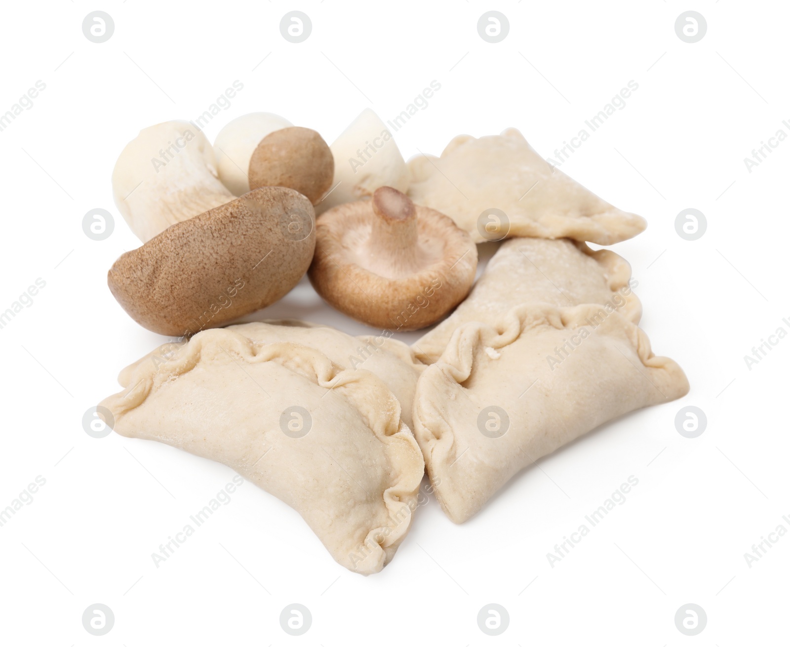 Photo of Raw dumplings (varenyky) and fresh mushrooms isolated on white