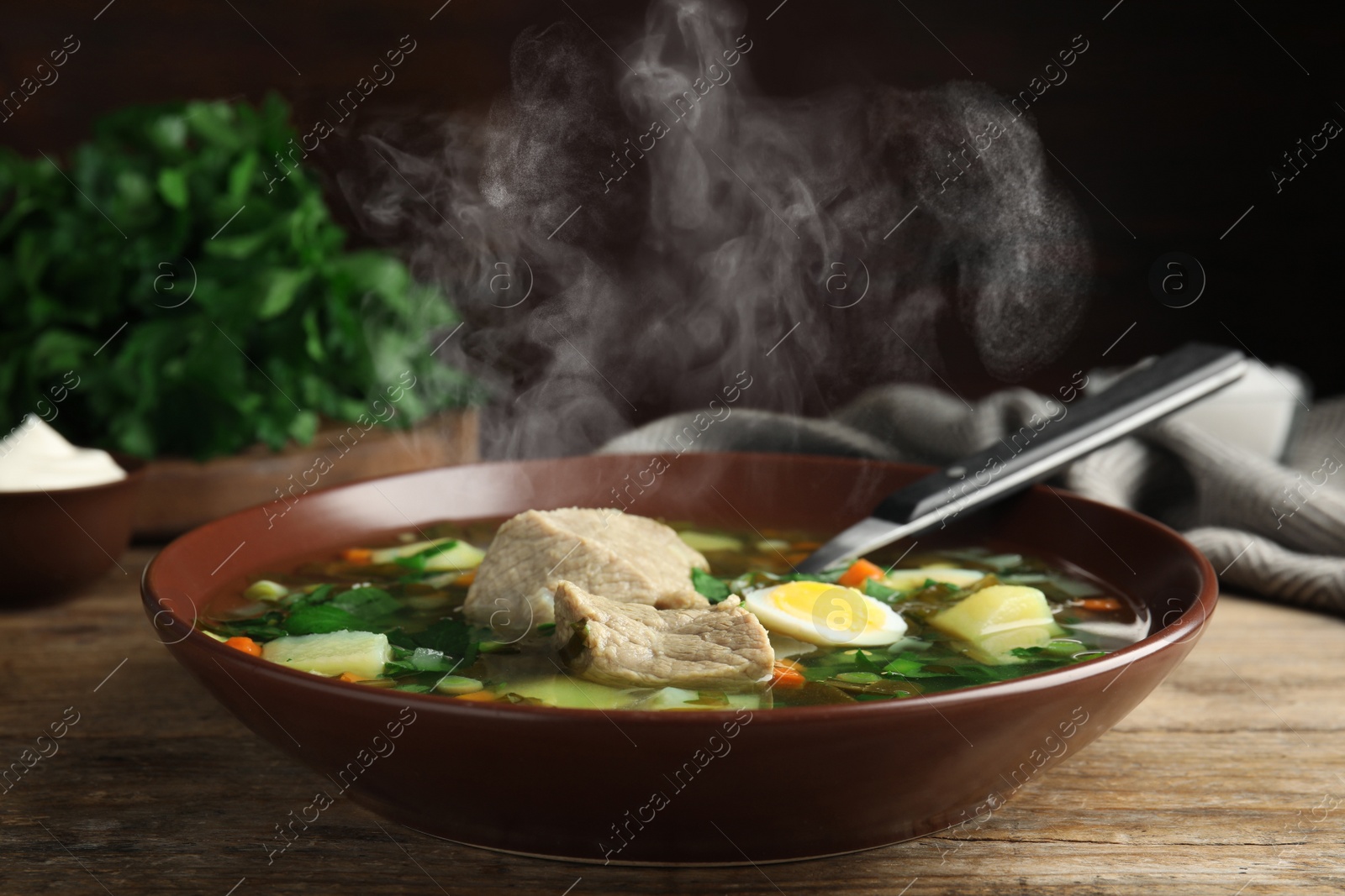 Image of Delicious sorrel soup with meat and egg served on wooden table