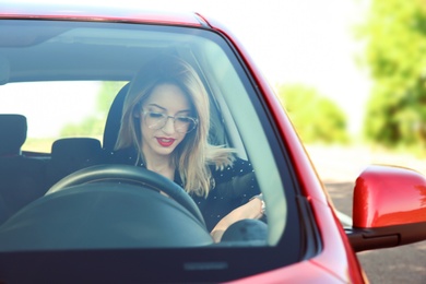 Photo of Young woman on driver's seat of car