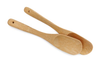 Wooden spoons on white background, top view