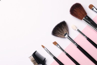 Photo of Different makeup brushes on color background, flat lay. Space for text