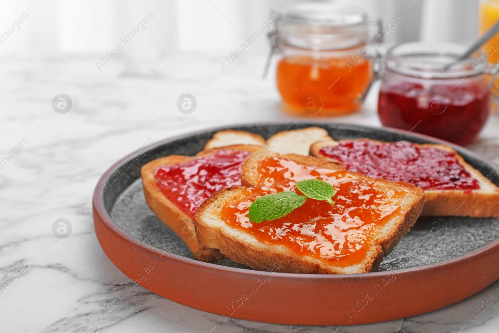 Photo of Toasts with jam on plate, closeup