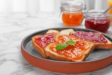 Photo of Toasts with jam on plate, closeup