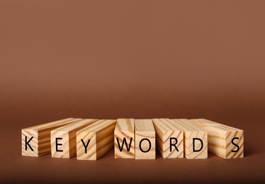 Photo of Blocks with word KEYWORDS on brown background