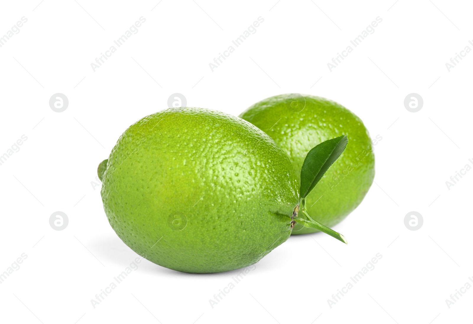 Photo of Fresh ripe limes with green leaf isolated on white