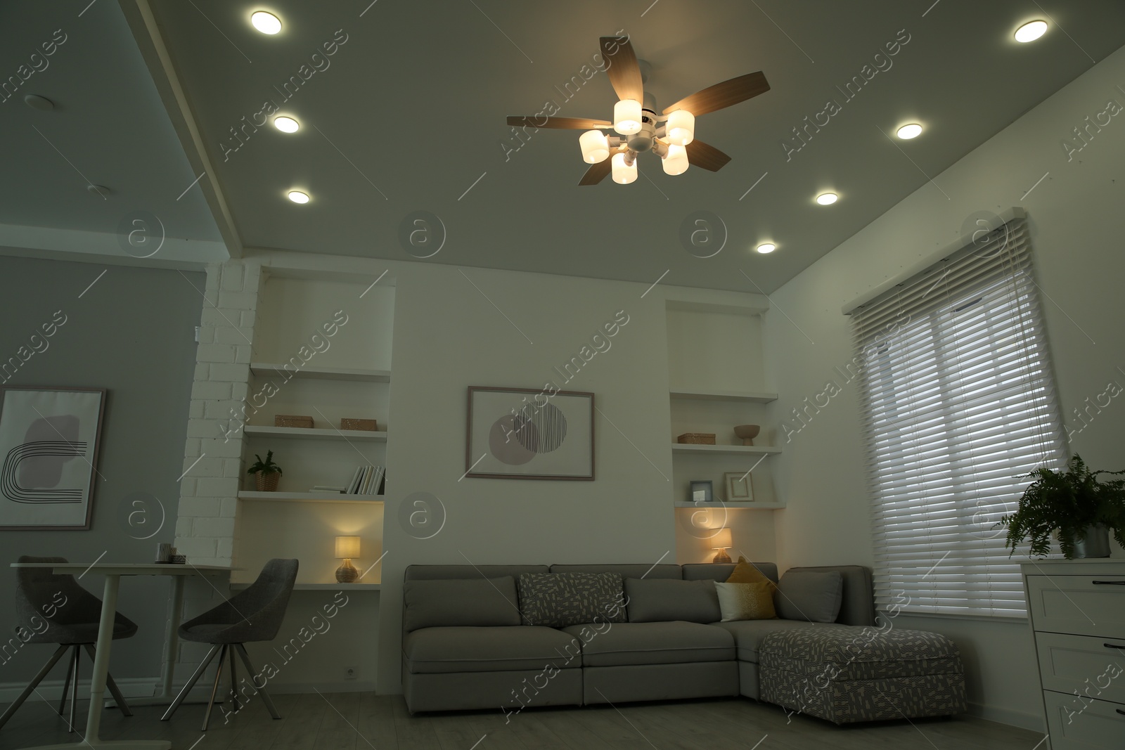 Photo of Ceiling fan, furniture and accessories in stylish living room, low angle view