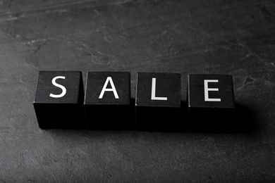 Photo of Cubes with word Sale on dark background. Black Friday concept