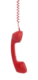 Photo of Red corded telephone handset hanging on white background. Hotline concept