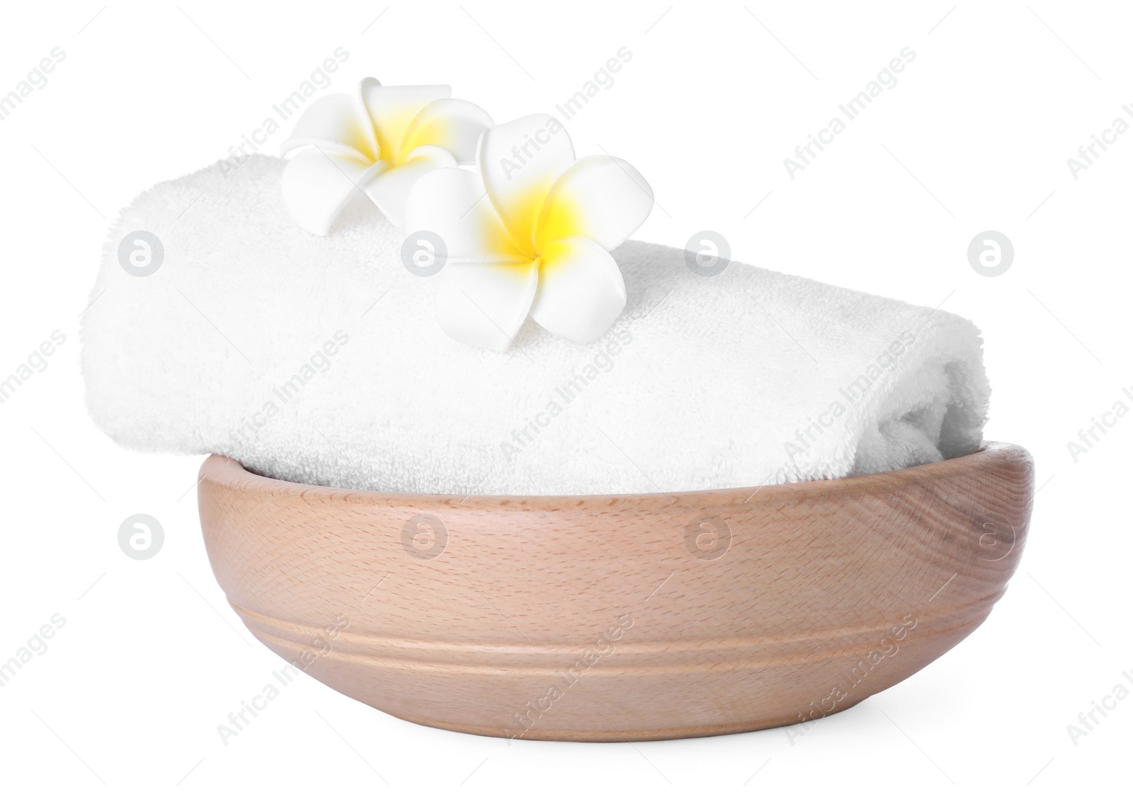 Photo of Wooden bowl with towel and flowers isolated on white. Spa supplies