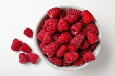 Photo of Bowl of delicious ripe raspberries on white background, top view