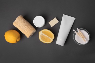 Lemon face wash. Fresh citrus fruits and personal care products on dark grey background, flat lay