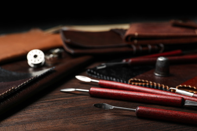 Photo of Leather samples and tools on wooden table