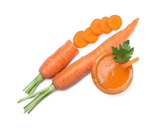 Freshly made carrot juice in glass on white background, top view