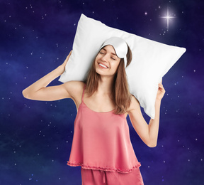 Image of Beautiful woman with pillow and night starry sky moon on background. Bedtime