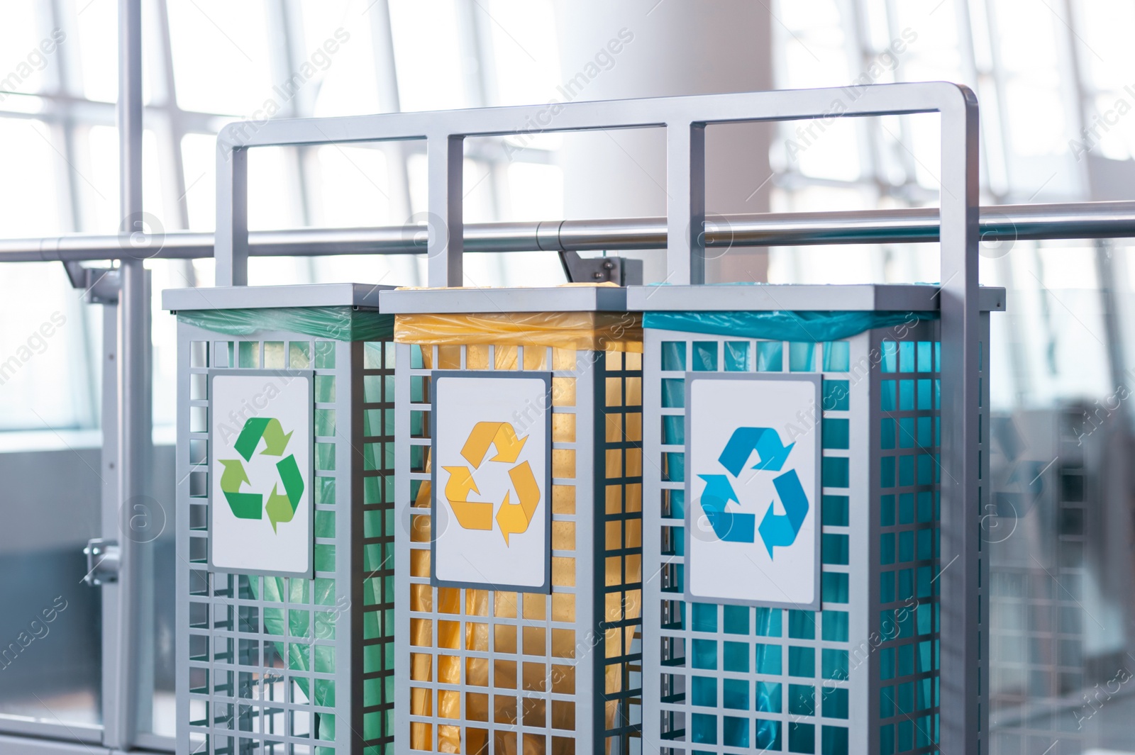 Photo of Color waste sorting bins indoors. Recycling concept