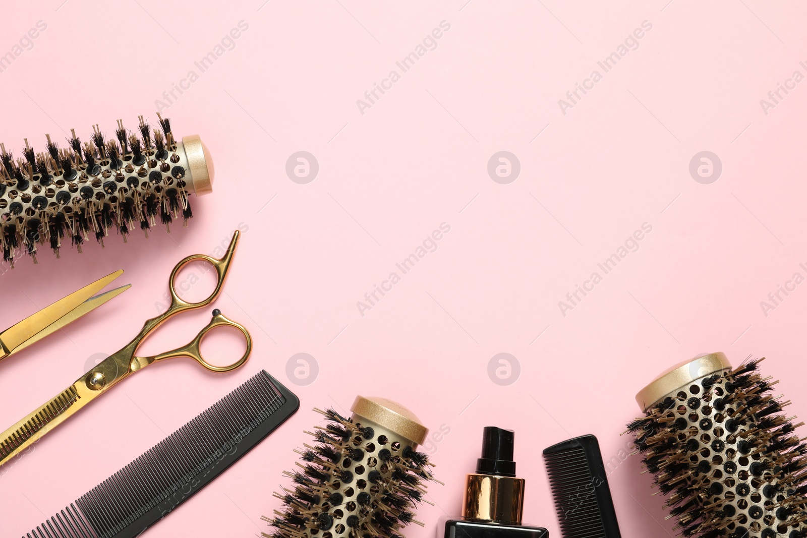 Photo of Professional hair dresser tools on pink background, flat lay. Space for text