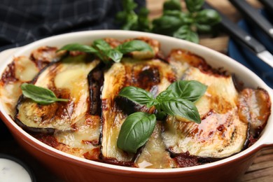 Photo of Delicious eggplant lasagna in baking dish on table, closeup