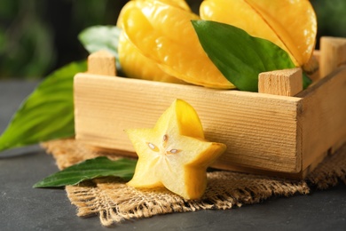 Delicious carambola fruits and slice on black table