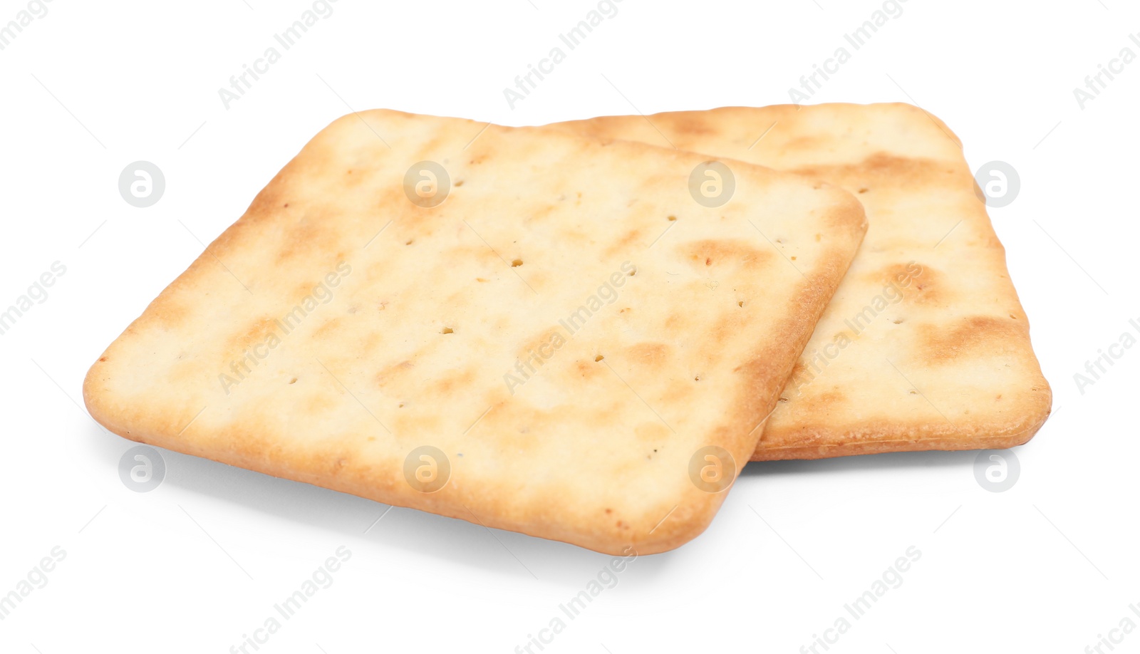 Photo of Tasty crispy square crackers isolated on white