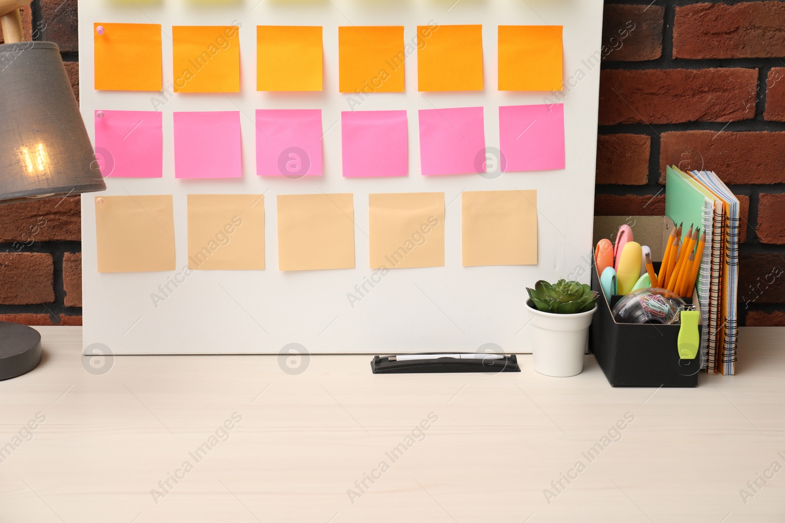 Photo of Business process planning and optimization. Workplace with colorful paper notes and other stationery on table