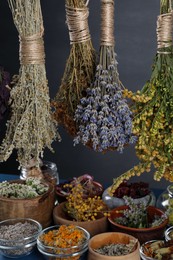 Many different herbs and flowers on grey background