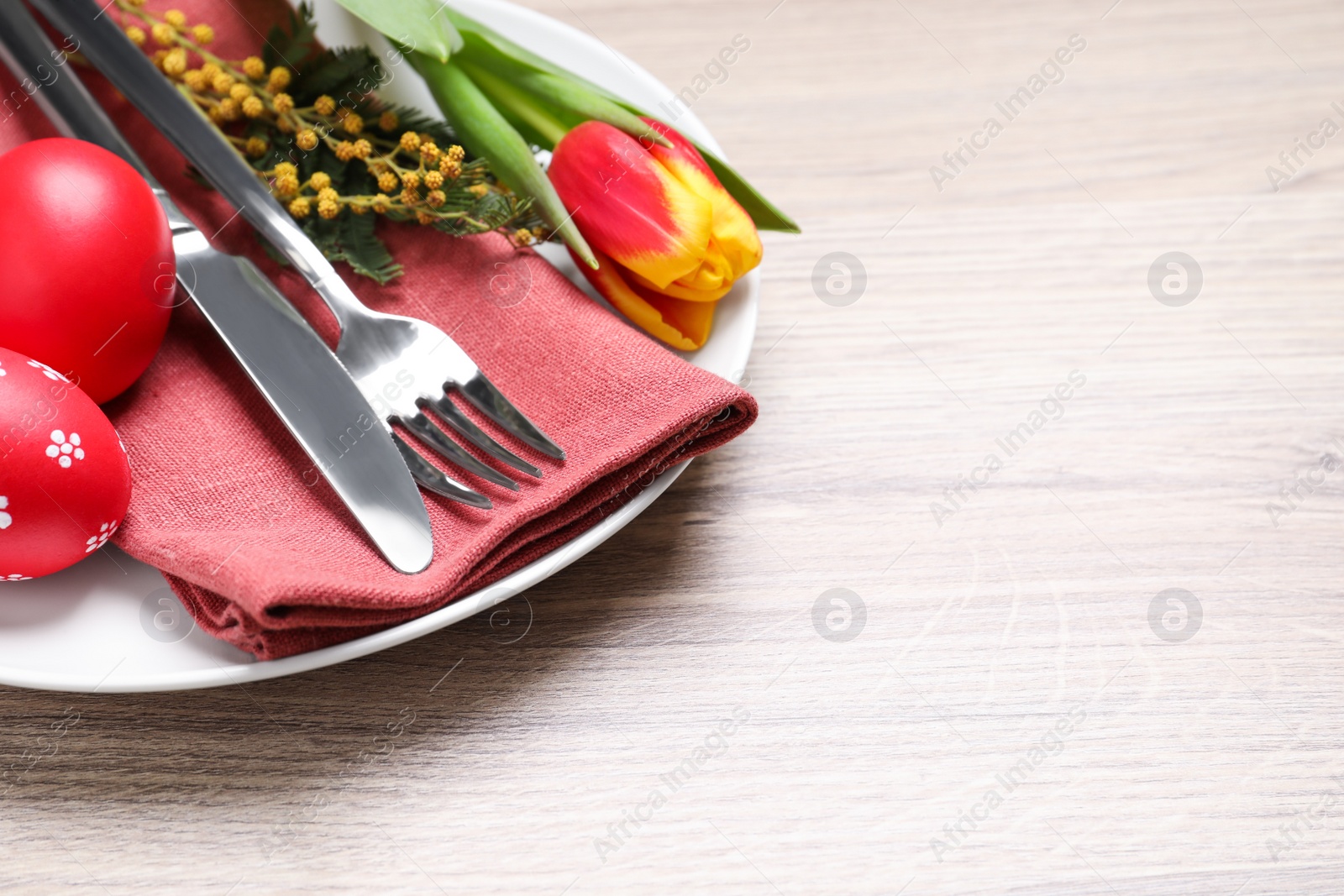 Photo of Festive Easter table setting with eggs on wooden background, closeup. Space for text