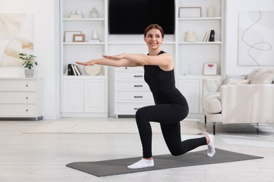 Photo of Happy woman doing morning exercise at home, space for text
