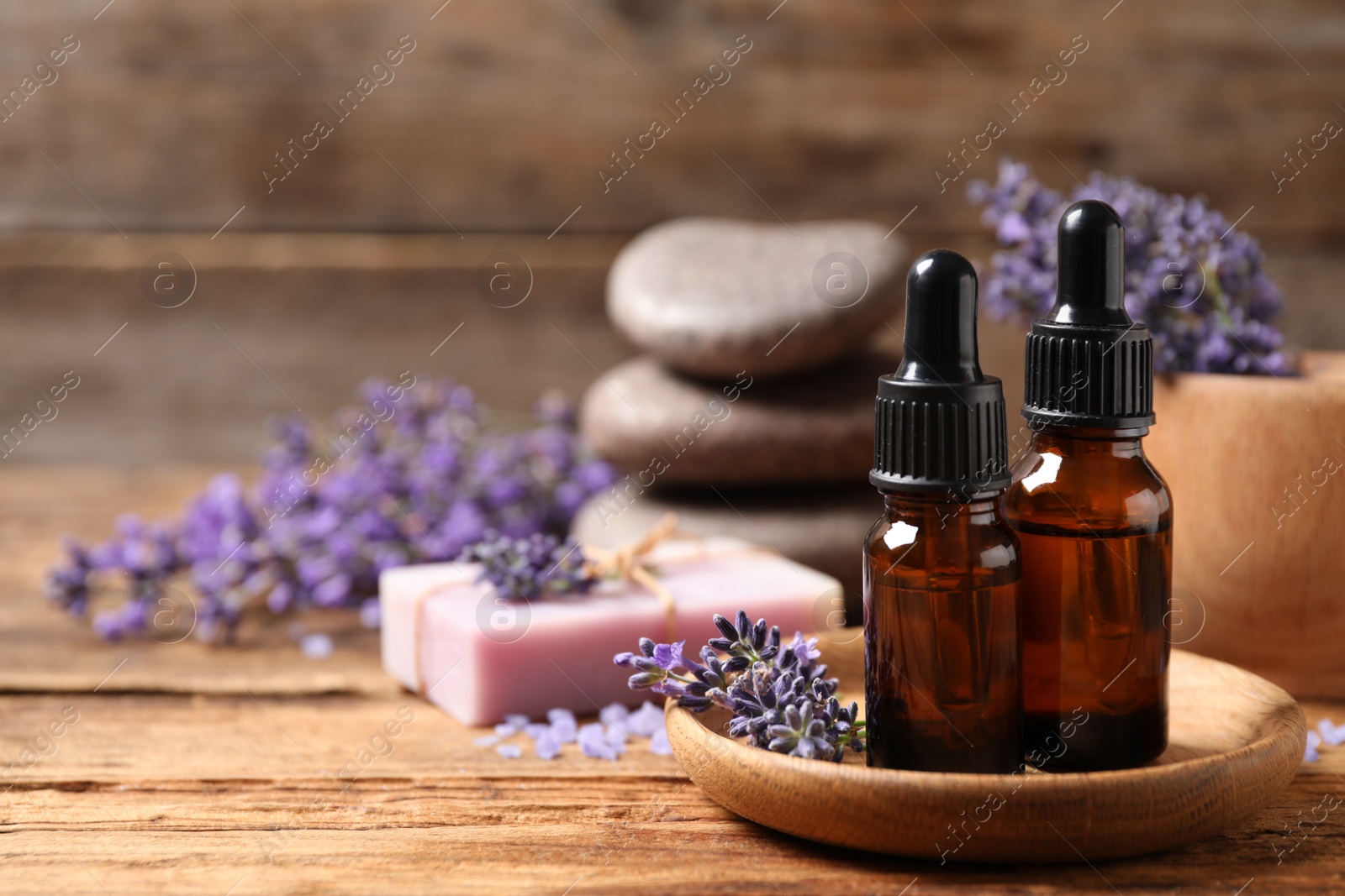 Photo of Cosmetic products and lavender flowers on wooden table. Space for text