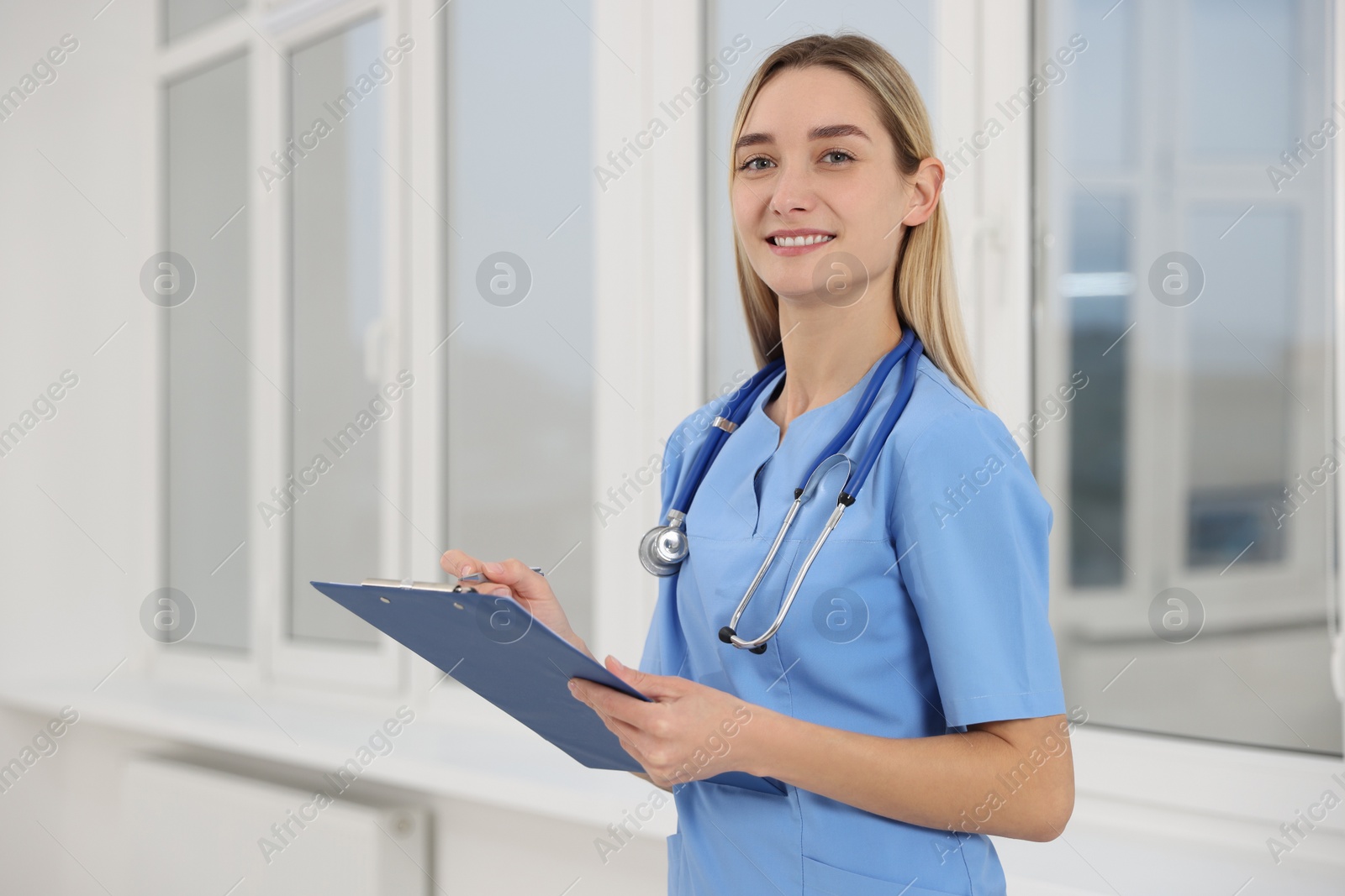 Photo of Portrait of young intern wearing uniform in university hall, space for text