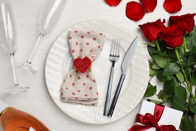 Beautiful table setting with gift box and bouquet for romantic dinner, flat lay