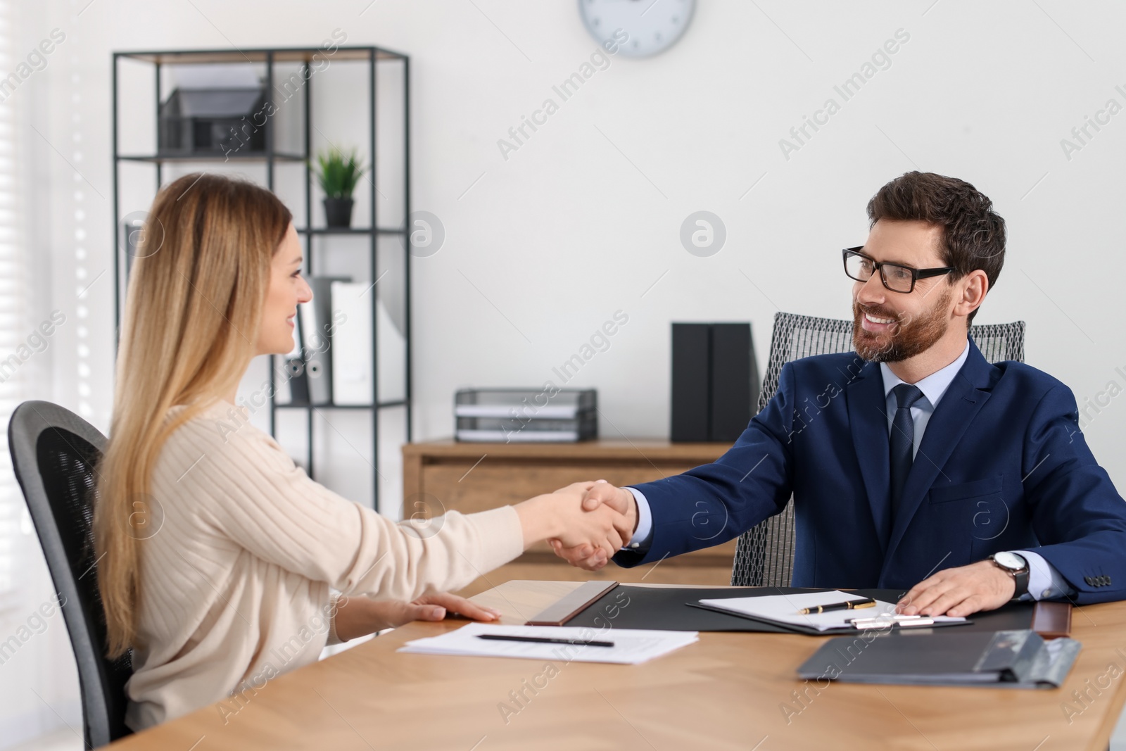 Photo of Lawyer shaking hands with client in office